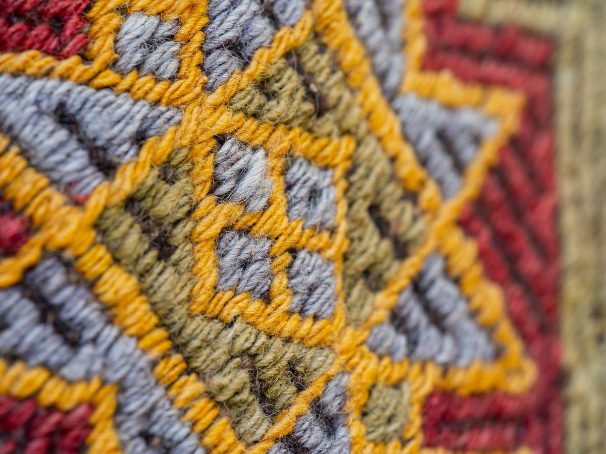 Close-up comparison of plain berber vs. patterned berber showing tonal variation and loop height differences