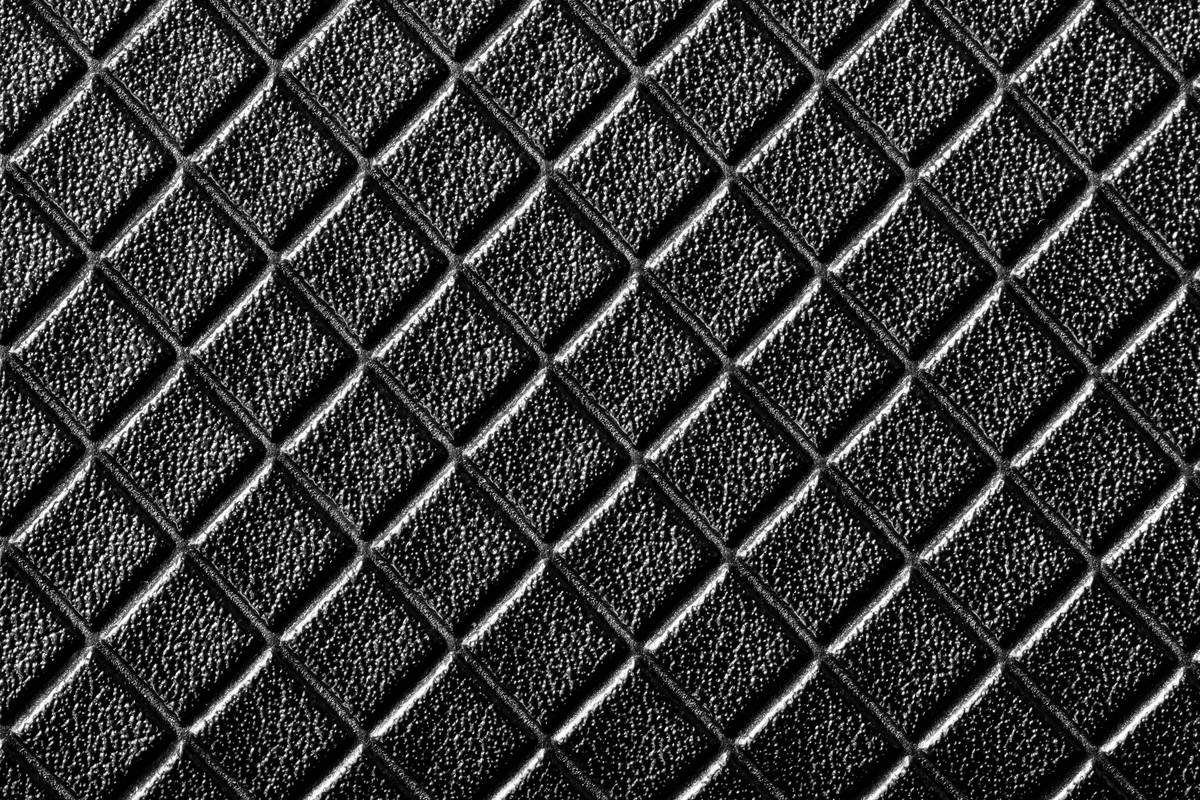 Cross-section diagram showing how dirt penetrates beneath Berber carpet loops versus sitting on top of cut-pile carpet fibers