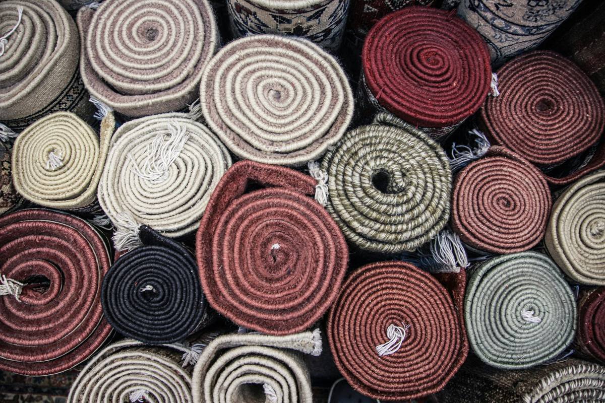 Infographic comparing five types of Berber carpet by fiber, pile style, durability, and best-use locations