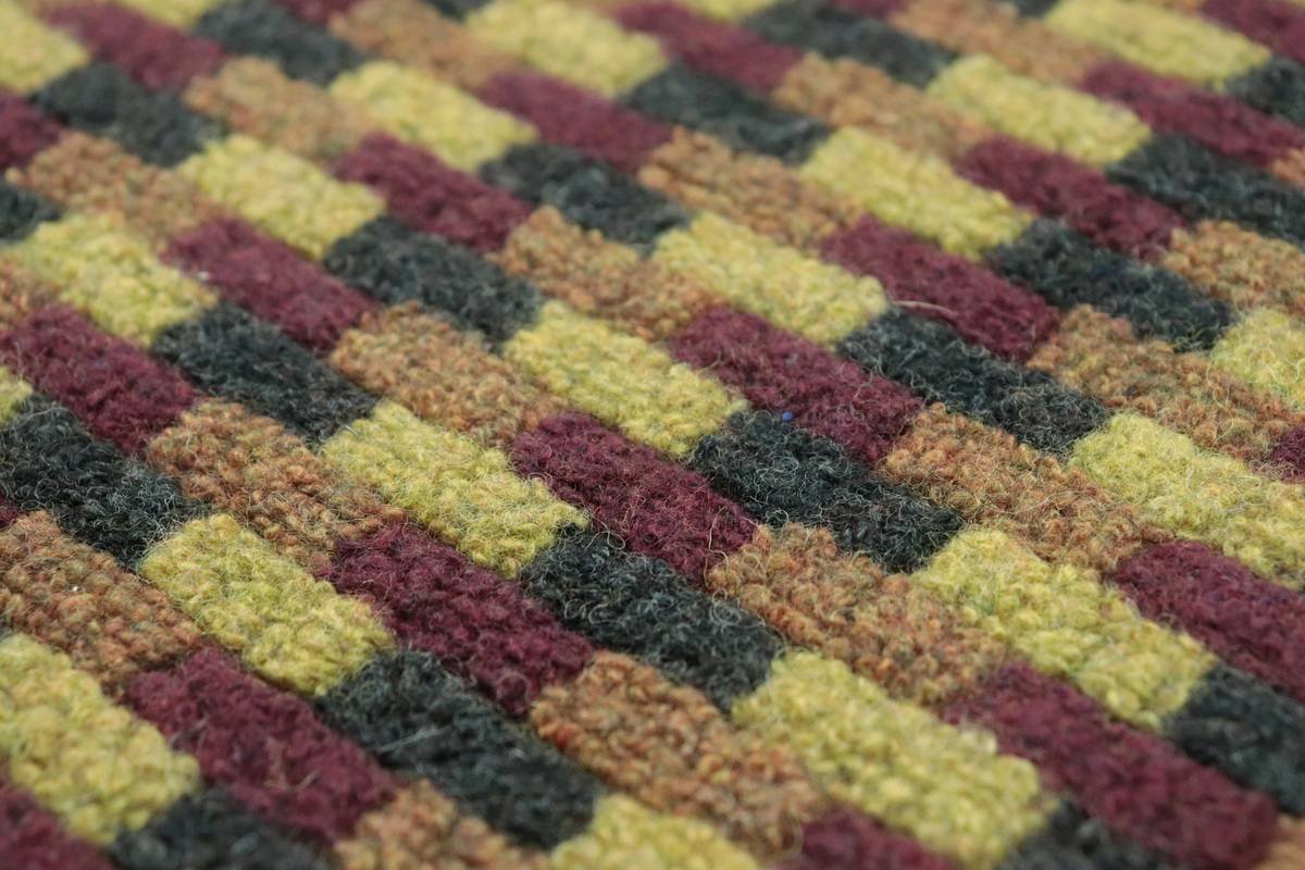 Side-by-side comparison of traditional solid beige Berber vs. modern berber carpet with tonal geometric weave design