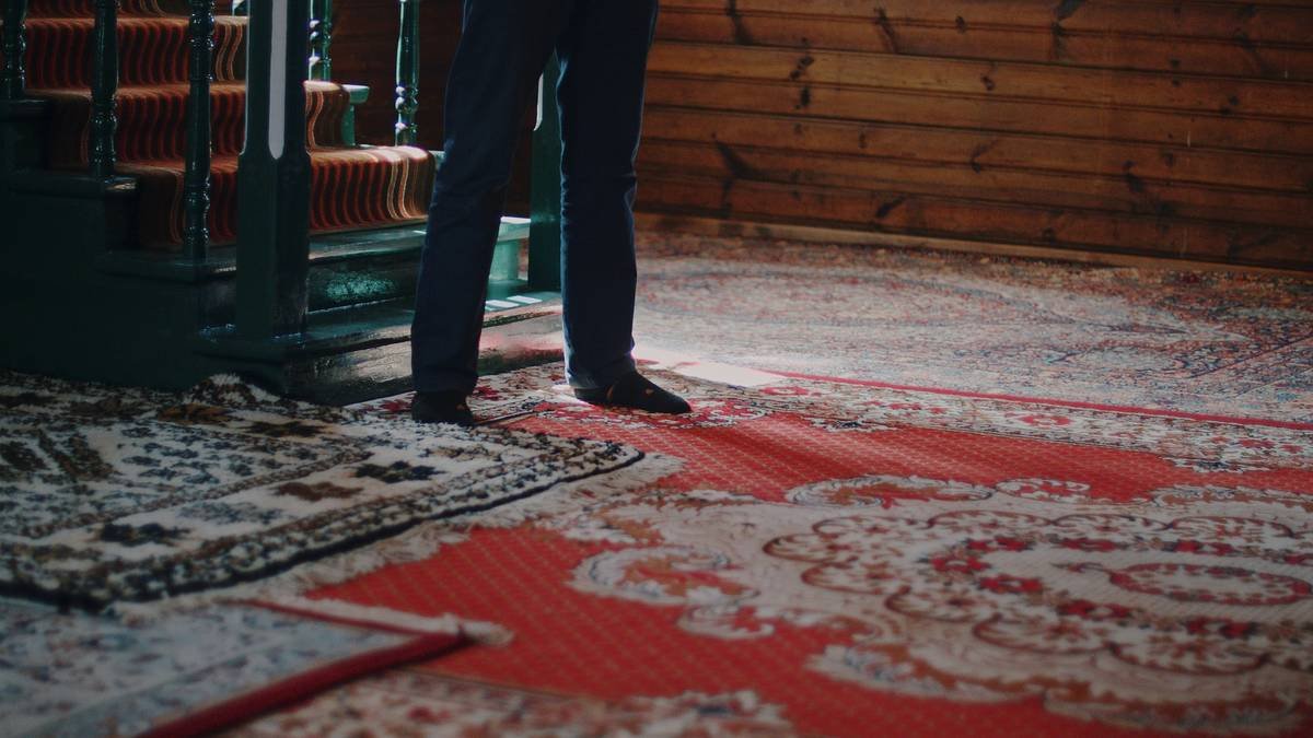 Close-up of properly stretched berber carpet edge secured with tack strips during how to install berber carpet process