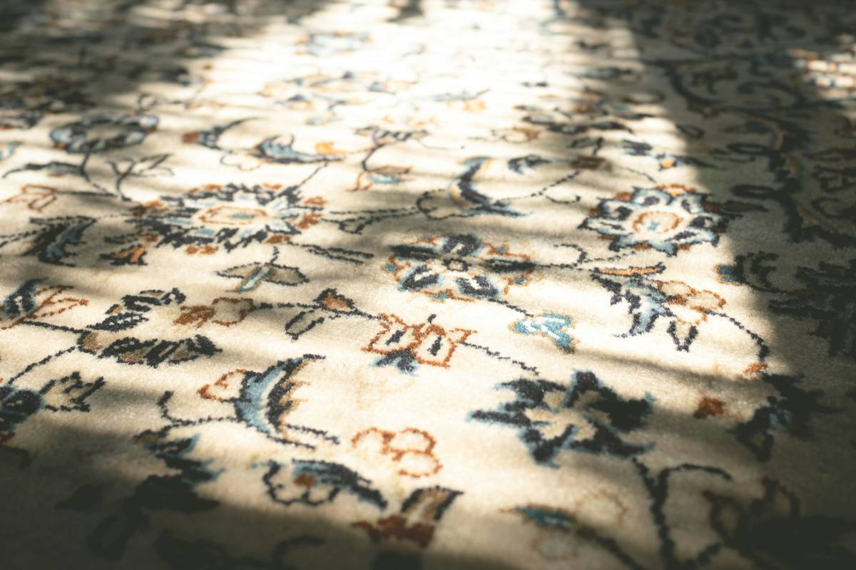 Close-up of berber carpet with pattern showing multi-level loops and heathered color variation
